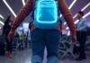 15 Must-Have Travel Gadgets Every Globetrotter Needs in 2025 Neon backpack gadgets in chaotic airport trip