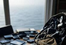 Top 10 Budget-Friendly Travel Gadgets You’ll Actually Usef Cluttered desk gadgets, foggy Lake Michigan view