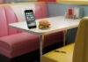 Top 10 Must-Have Apps in 2025 That Will Change Your Daily Life Diner booth, glowing phone, sad burger, chewed pen