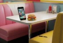 Top 10 Must-Have Apps in 2025 That Will Change Your Daily Life Diner booth, glowing phone, sad burger, chewed pen