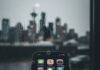 Hidden Gem Apps You Didn’t Know You Needed—Download Them Now! Phone screen with sparkling apps in a rainy Seattle coffee shop