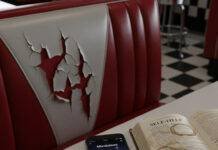 Best Apps for Mental Health and Wellness: Your Path to Calm in 2025 Diner booth, cracked seat, phone with mindfulness app, self-help book