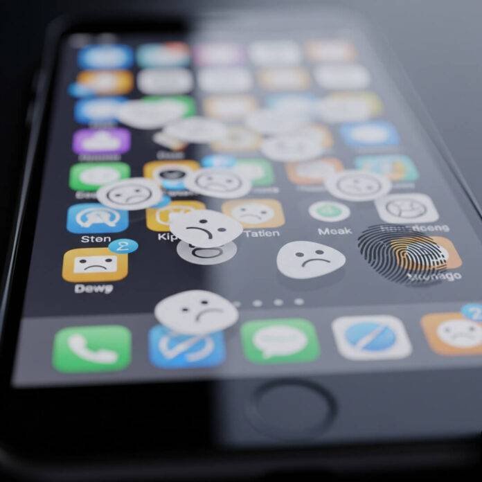 Smudged phone screen with frowny face app icons Smudged phone screen with frowny face app icons