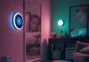 10 Genius Smart Home Gadgets That Will Change Your Life in 2025 Cluttered living room with smart thermostat, robot vacuum, spilled coffee, and smart mirror reflecting sleepy face, muted neon tones