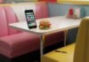 Top 10 Must-Have Apps in 2025 That Will Change Your Daily Life Diner booth, glowing phone, sad burger, chewed pen