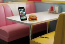 Top 10 Must-Have Apps in 2025 That Will Change Your Daily Life Diner booth, glowing phone, sad burger, chewed pen