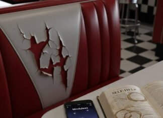 Best Apps for Mental Health and Wellness: Your Path to Calm in 2025 Diner booth, cracked seat, phone with mindfulness app, self-help book